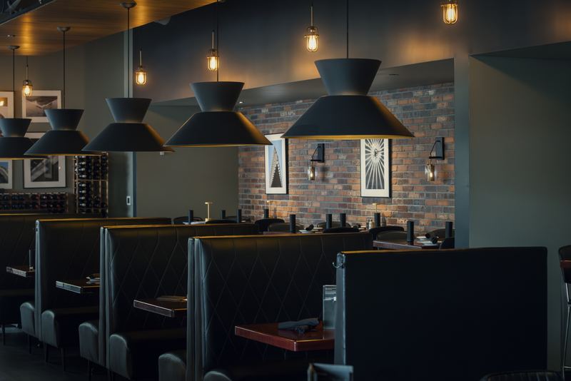 High-backed booths, pendant lights and gallery walls in the Domenic’s dining room