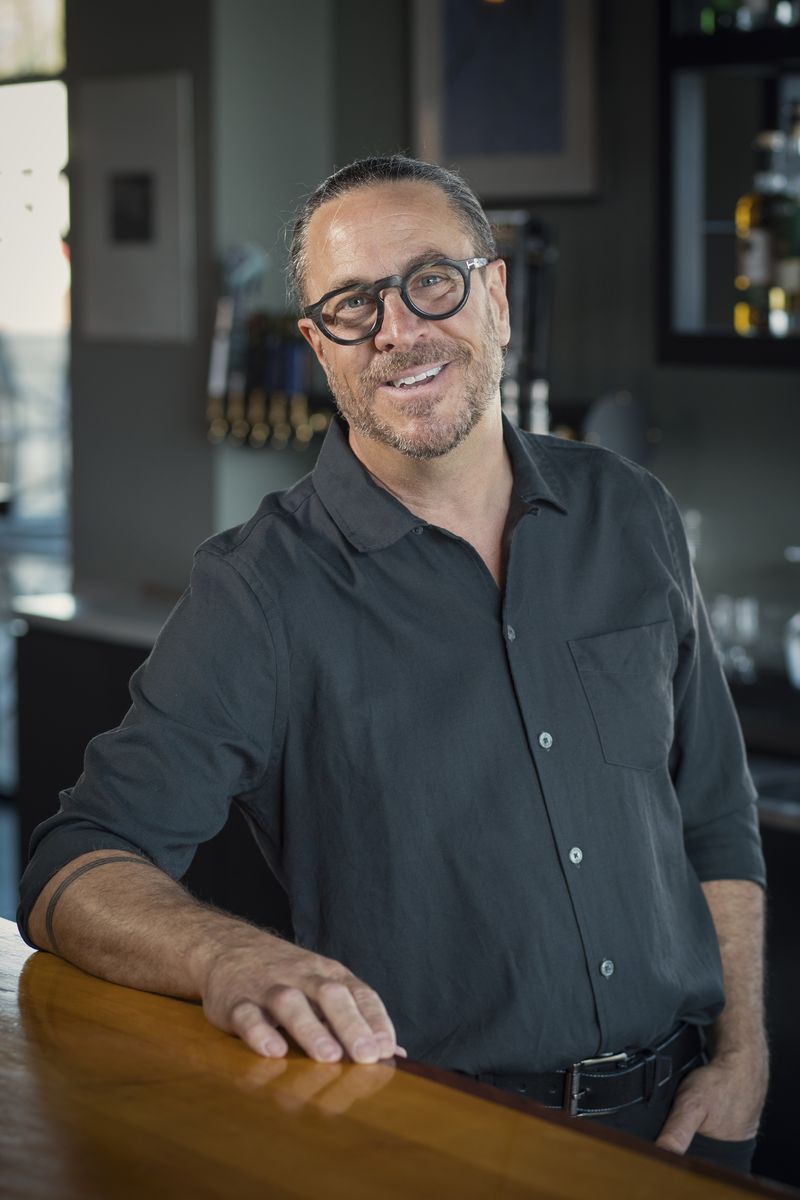 Brian Tessari leaning on the bar at Domenic’s