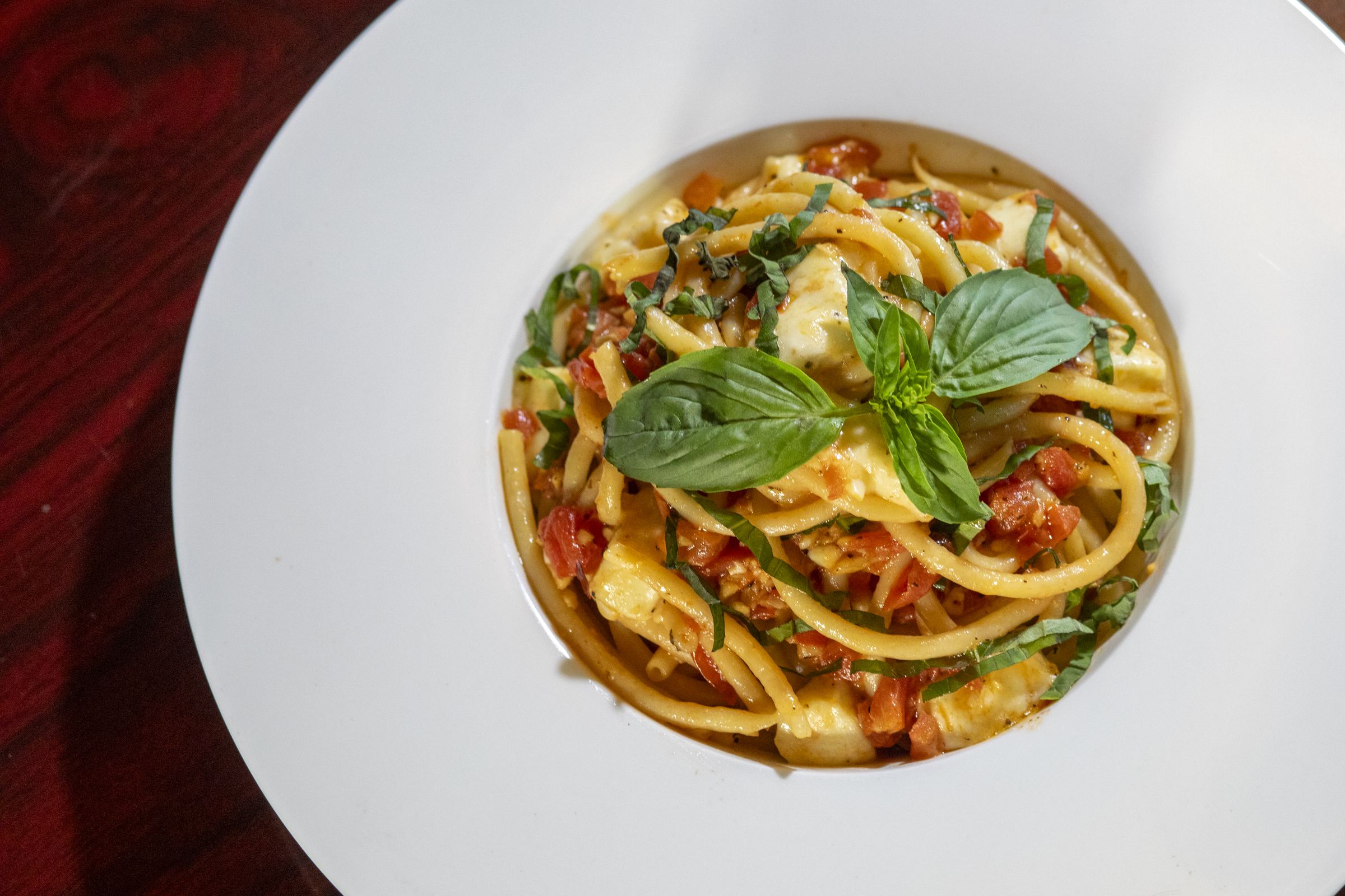 A plate of house-made pasta with basil