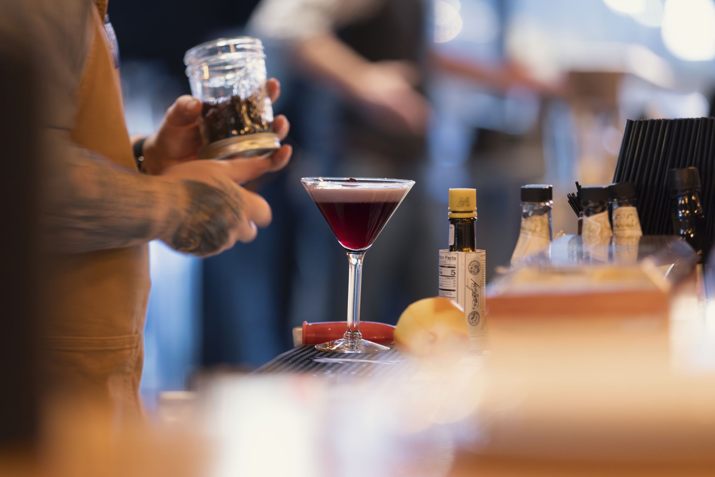 A deep red cocktail on the bar