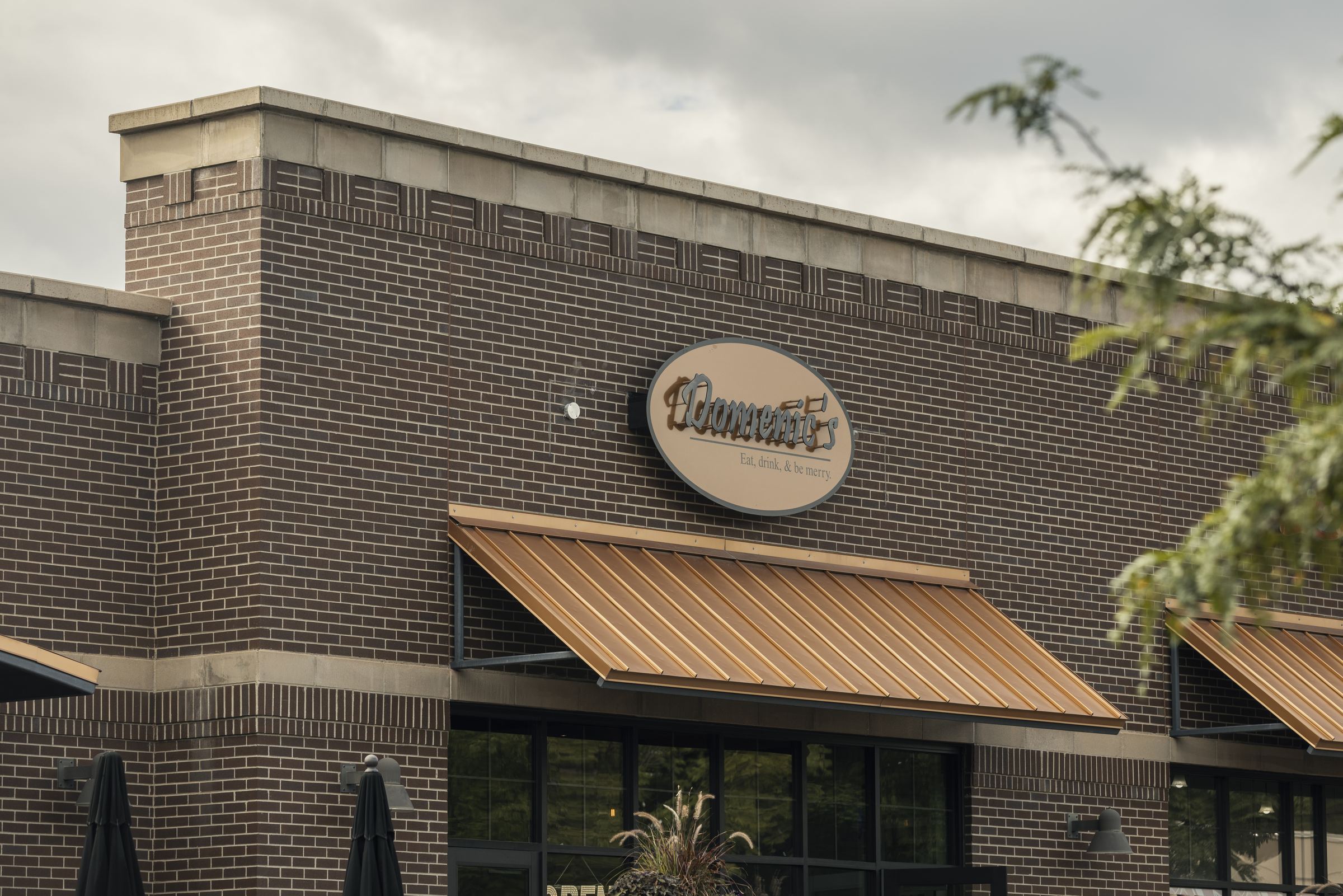 The brick exterior and sign of Domenic’s Bistro & Wine Bar