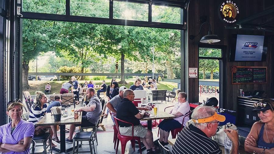 Guests filling ottoPINT with the garage doors open to the patio